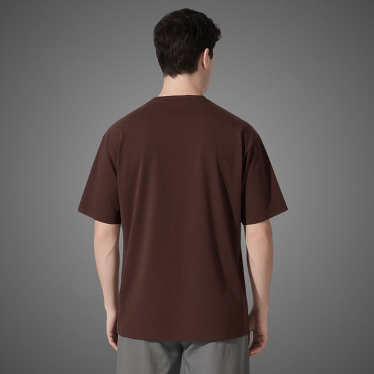 Man wearing a brown t-shirt on a gray background