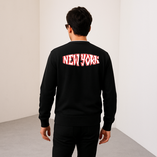Person wearing a black sweatshirt with 'New York' printed on the back against a plain background