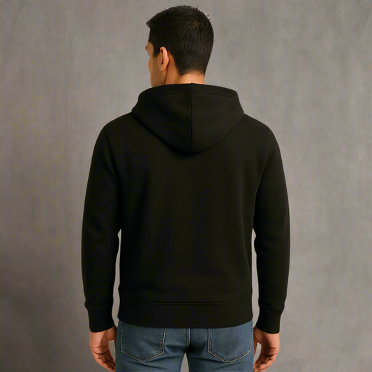 Person wearing a black hoodie from behind against a gray background