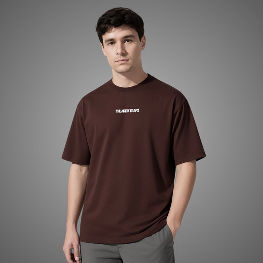 Man wearing a brown t-shirt with text on a gray background