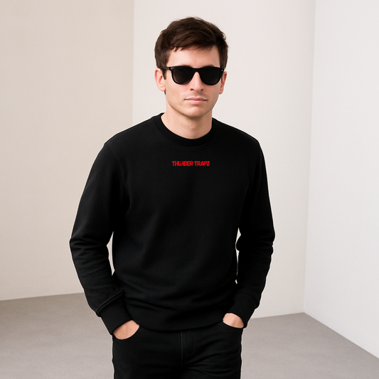 Man wearing a black sweatshirt with red text and sunglasses in a minimalistic setting