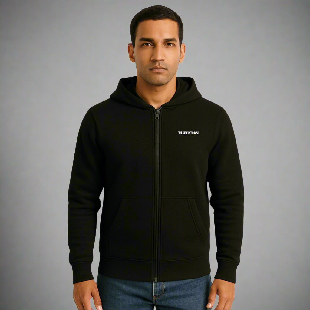 Man wearing a black hoodie with a logo on a gray background